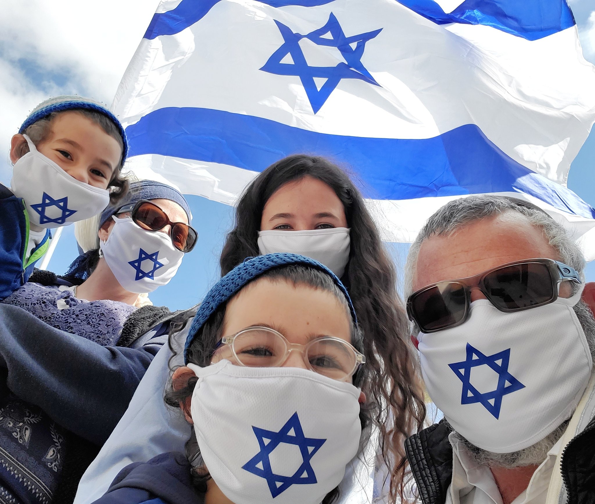 Israelis wearing patriotic masks